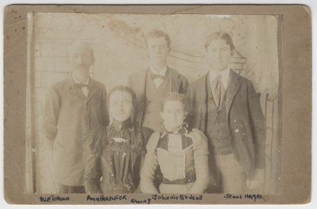 Group of men and women in front of backdrop